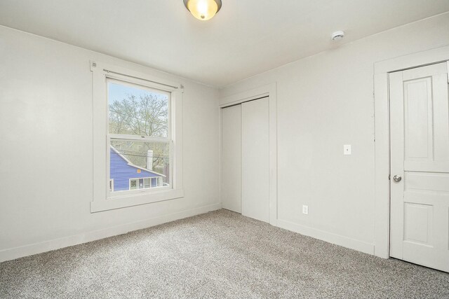 311 Robey Pl SE, Grand Rapids, MI 49506 - unfurnished bedroom with carpet, a closet, and baseboards