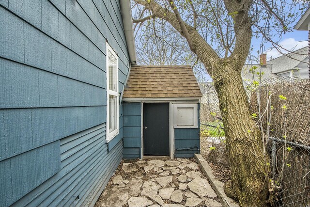 311 Robey Pl SE, Grand Rapids, MI 49506 - entrance to property featuring fence and roof with shingles