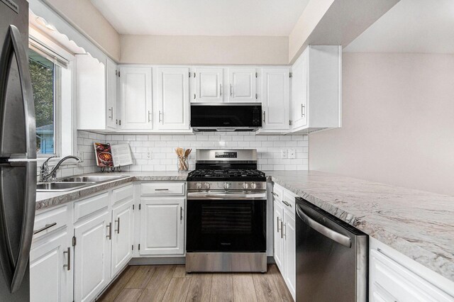 5984 Leisure S Dr SE, Grand Rapids, MI 49548 - kitchen with a sink, light countertops, tasteful backsplash, and stainless steel appliances