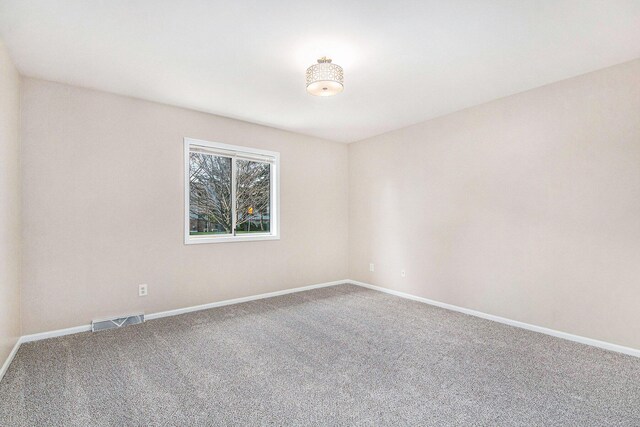 5984 Leisure S Dr SE, Grand Rapids, MI 49548 - spare room featuring visible vents, baseboards, and carpet floors