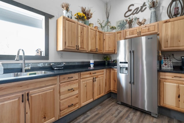 9528 Lee Rd, Jackson, MI 49201 - kitchen featuring dark wood-style flooring, dark countertops, a sink, and stainless steel fridge with ice dispenser