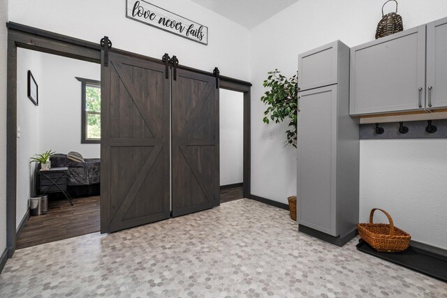 9528 Lee Rd, Jackson, MI 49201 - mudroom featuring baseboards and a barn door