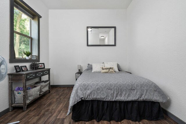 9528 Lee Rd, Jackson, MI 49201 - bedroom with baseboards and dark wood finished floors