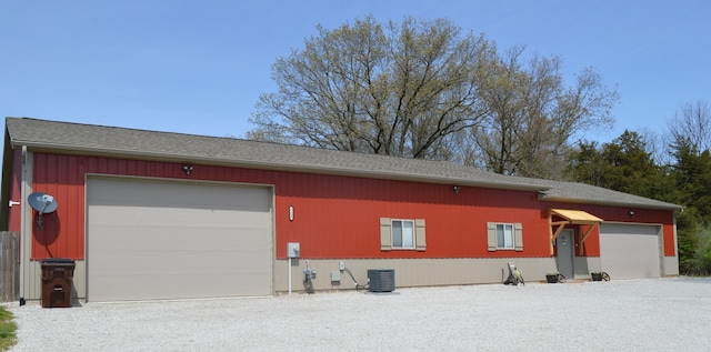 9528 Lee Rd, Jackson, MI 49201 - view of property exterior with a garage, central air condition unit, and a shingled roof
