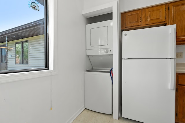 5160 Green Meadow Rd, Kalamazoo, MI 49009 - laundry room with light tile patterned floors, laundry area, and stacked washer and dryer