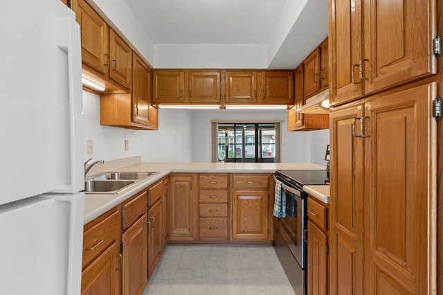 5160 Green Meadow Rd, Kalamazoo, MI 49009 - kitchen with brown cabinets, stainless steel range with electric cooktop, a sink, light countertops, and freestanding refrigerator
