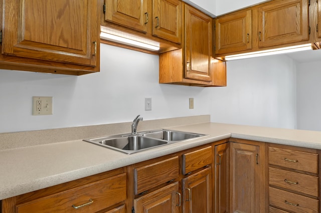 5160 Green Meadow Rd, Kalamazoo, MI 49009 - kitchen featuring light countertops, brown cabinets, and a sink