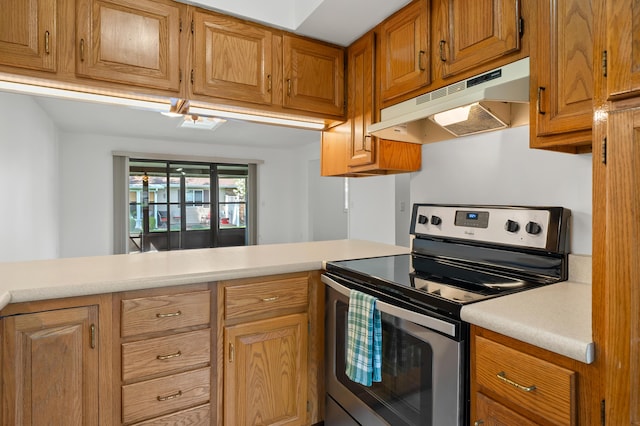 5160 Green Meadow Rd, Kalamazoo, MI 49009 - kitchen featuring brown cabinetry, a peninsula, light countertops, under cabinet range hood, and electric stove
