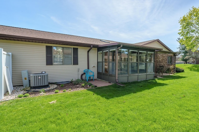 5160 Green Meadow Rd, Kalamazoo, MI 49009 - back of property featuring a yard, central AC unit, and a sunroom
