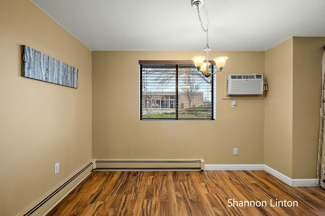 unfurnished room with a wall mounted air conditioner, a baseboard heating unit, an inviting chandelier, and wood finished floors