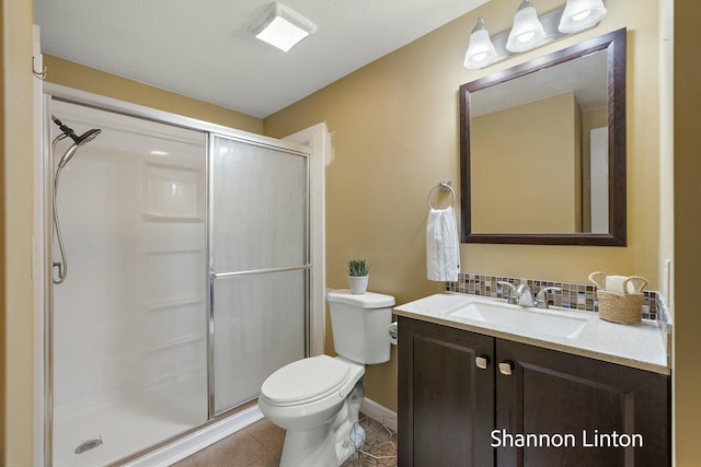 full bathroom with a shower stall, toilet, tile patterned floors, vanity, and backsplash