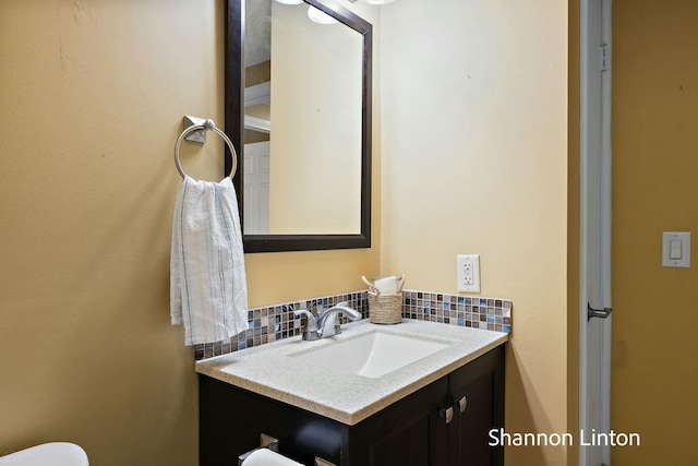 bathroom featuring vanity and decorative backsplash