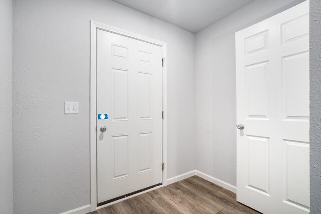 2710 Sanderling Ct, Grand Rapids, MI 49505 - doorway with baseboards and dark wood-type flooring