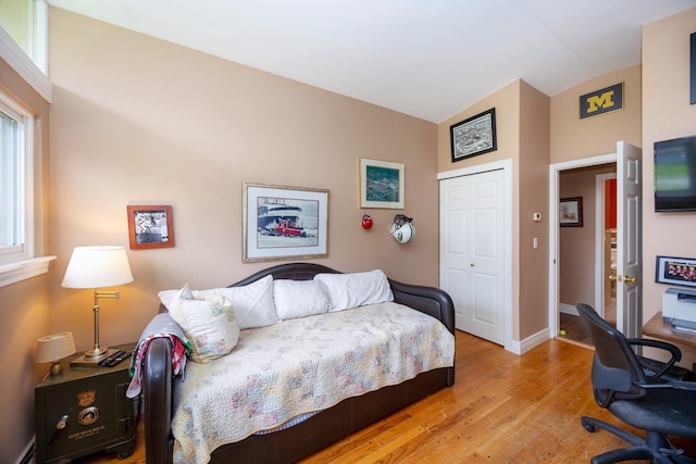 5009 John Holmes Rd, Ann Arbor, MI 48103 - bedroom with lofted ceiling, wood finished floors, a closet, a desk, and a baseboard heating unit