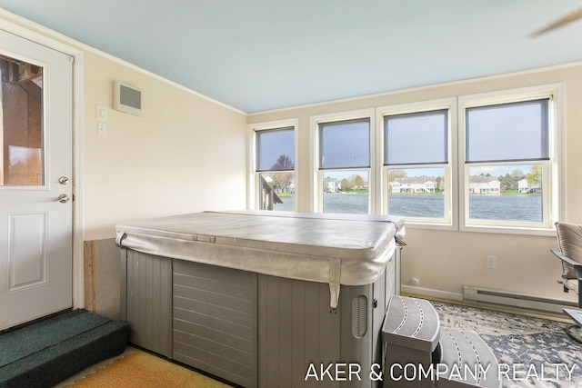interior space featuring baseboards, a water view, visible vents, ornamental molding, and a baseboard heating unit