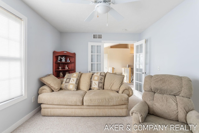 carpeted living room with french doors, baseboards, a ceiling fan, and visible vents