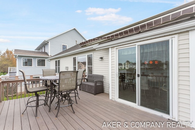 wooden deck with outdoor dining space