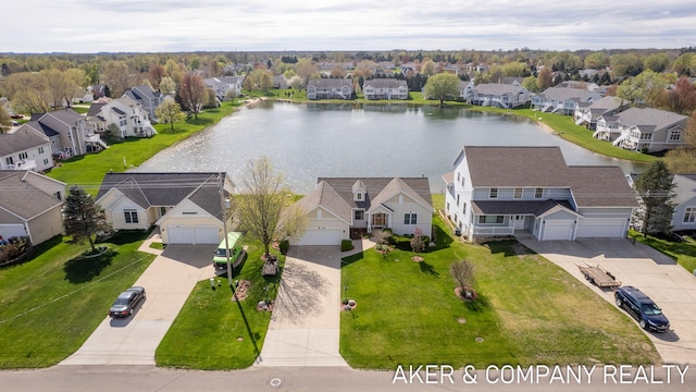 drone / aerial view featuring a water view and a residential view