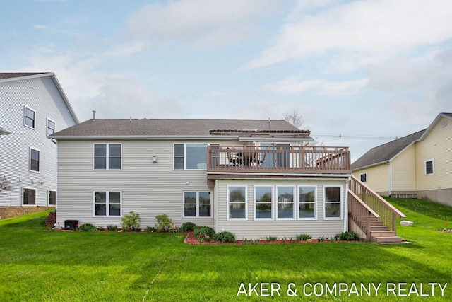 rear view of house with stairs, a yard, and a deck