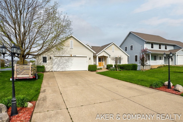 view of front of house featuring concrete driveway, an attached garage, and a front lawn