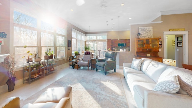 living room with ornamental molding, recessed lighting, and baseboards