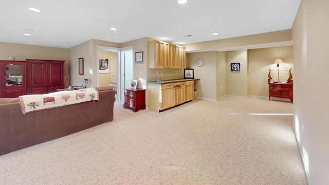 kitchen featuring recessed lighting, light brown cabinetry, light carpet, baseboards, and open floor plan