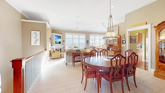 dining room with baseboards, recessed lighting, a fireplace, and crown molding