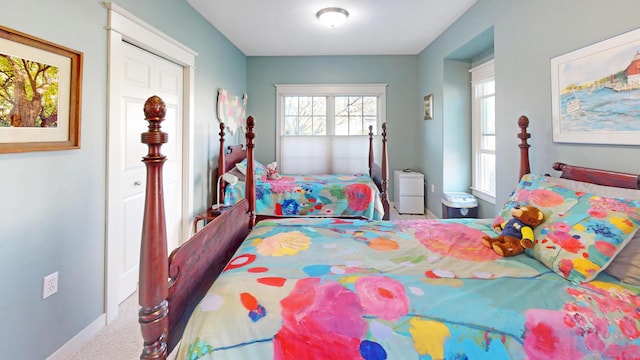 bedroom featuring baseboards and carpet flooring