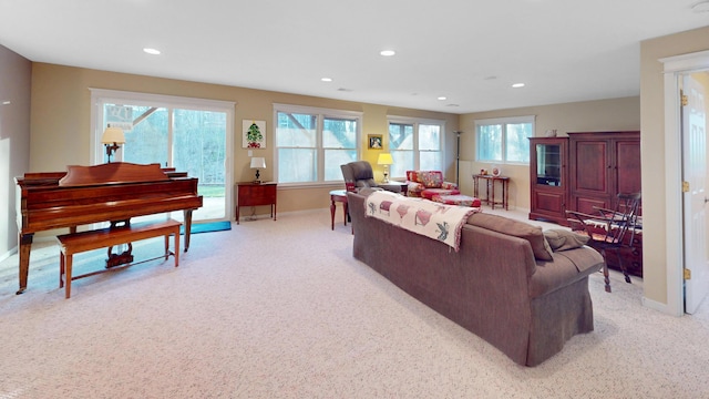 living room featuring baseboards, recessed lighting, and light carpet