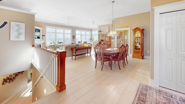 dining area with recessed lighting, ornamental molding, and baseboards