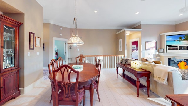 dining space featuring baseboards, recessed lighting, ornamental molding, and light wood finished floors