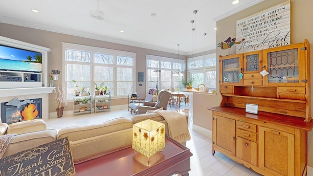 living area with recessed lighting, light tile patterned floors, a glass covered fireplace, baseboards, and crown molding