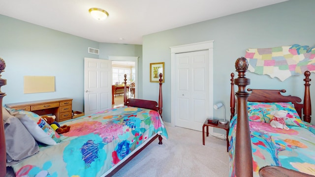 bedroom with visible vents, a closet, and carpet floors