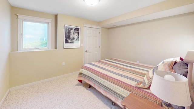 bedroom with baseboards and carpet floors