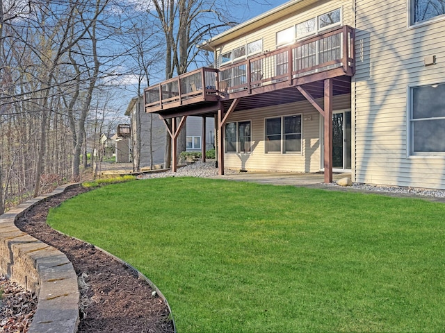 back of property featuring a wooden deck and a yard
