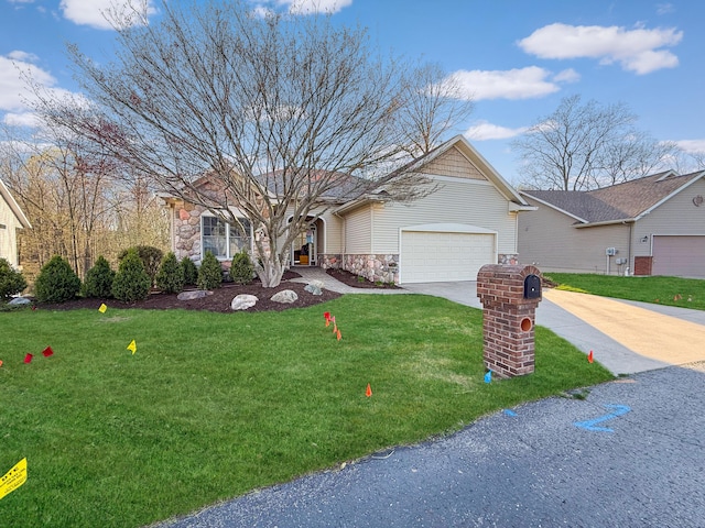 ranch-style home featuring a front yard, driveway, an attached garage, and stone siding
