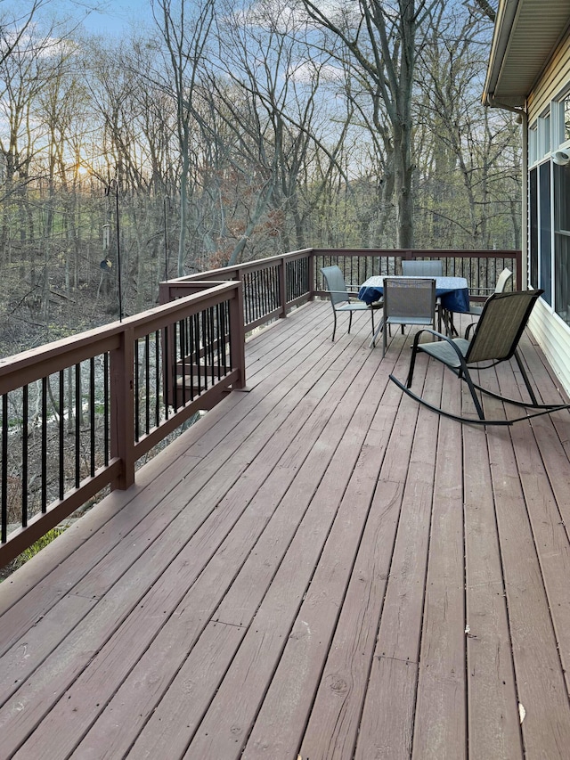 wooden terrace with outdoor dining space