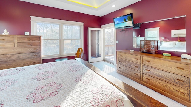 bedroom with recessed lighting, multiple windows, access to outside, and wood finished floors