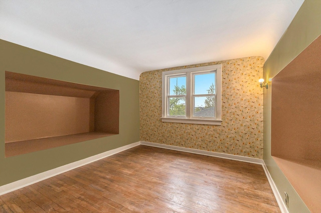 bonus room featuring hardwood / wood-style flooring, baseboards, and vaulted ceiling
