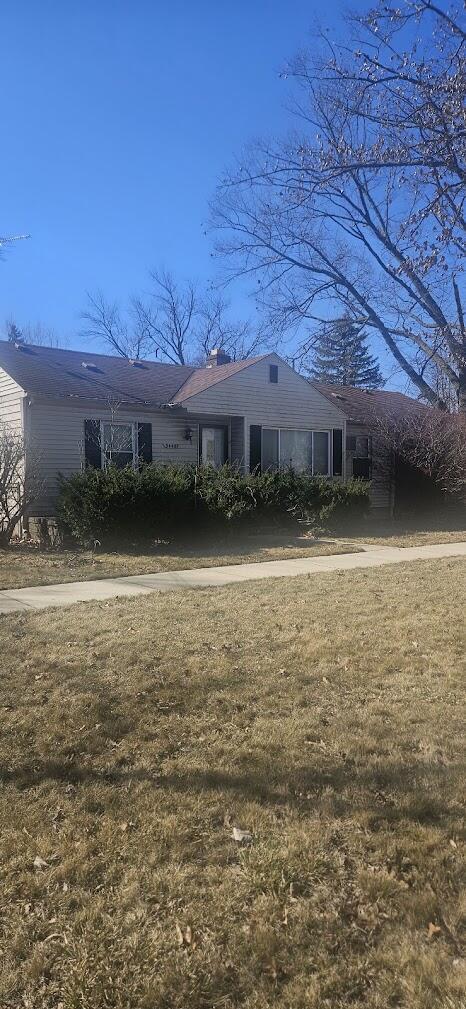 view of front of home featuring a chimney