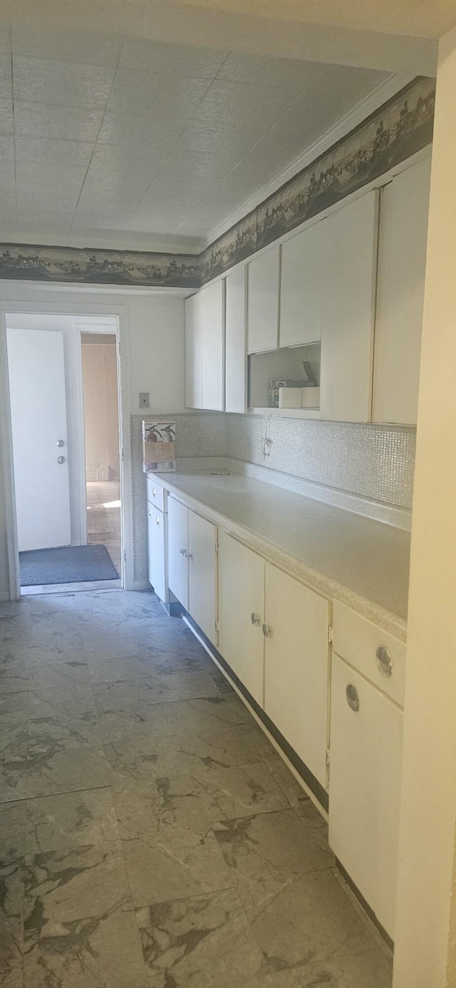 kitchen with light countertops and white cabinetry