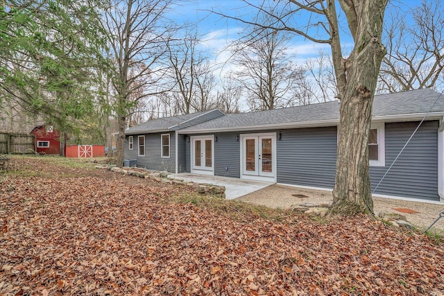 10985 E Cd Ave, Richland, MI 49083 - back of property featuring an outdoor structure, a shingled roof, a shed, fence, and french doors