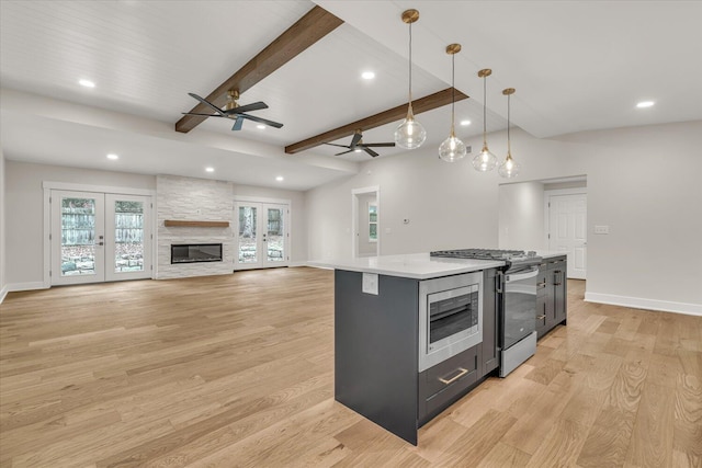 10985 E Cd Ave, Richland, MI 49083 - kitchen with recessed lighting, ceiling fan, gas range, and a fireplace