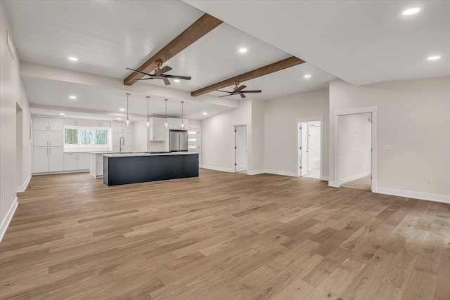10985 E Cd Ave, Richland, MI 49083 - unfurnished living room with a sink, light wood-type flooring, a ceiling fan, and baseboards