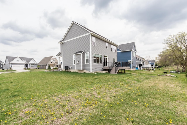 rear view of house with a yard and a deck