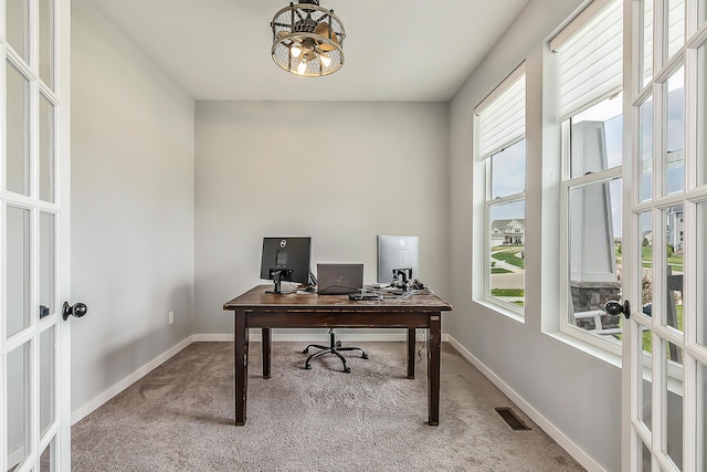 carpeted office featuring baseboards, plenty of natural light, french doors, and visible vents