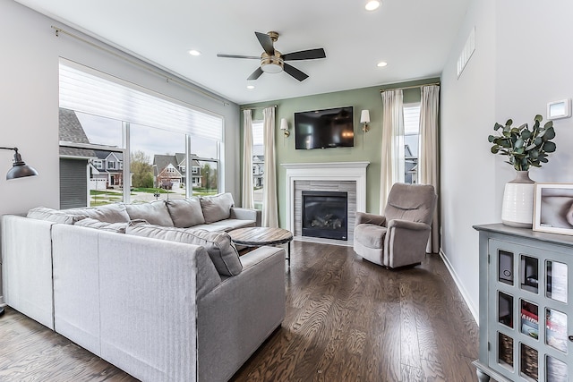 living room featuring recessed lighting, dark wood finished floors, ceiling fan, and a glass covered fireplace