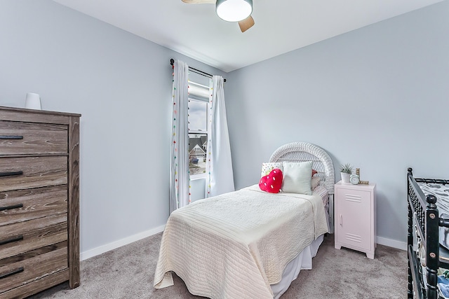 carpeted bedroom featuring baseboards and ceiling fan