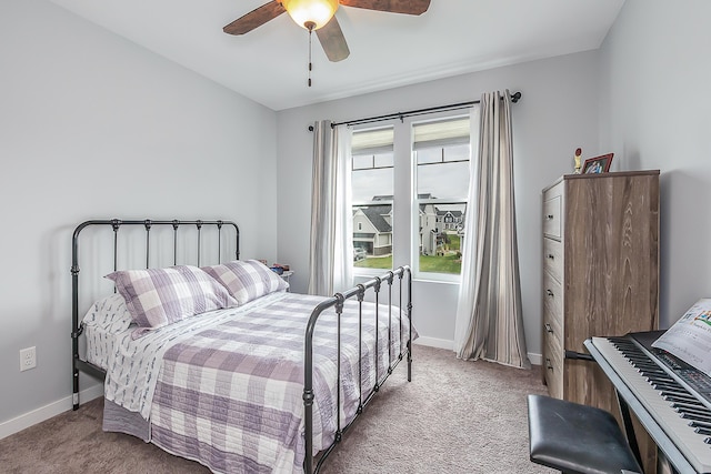 carpeted bedroom featuring a ceiling fan and baseboards