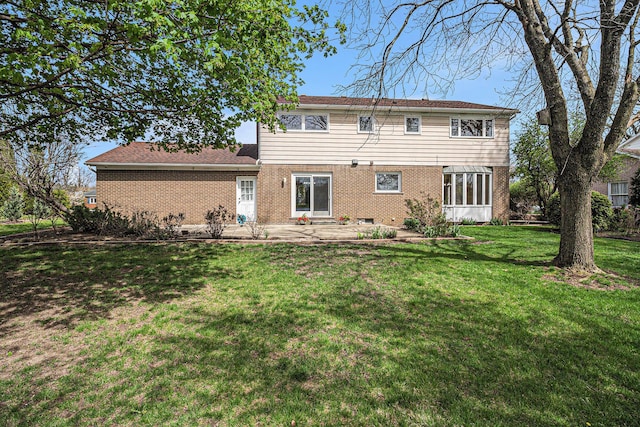 2038 S 7th St, Ann Arbor, MI 48103 - rear view of house featuring a yard, brick siding, and a patio area